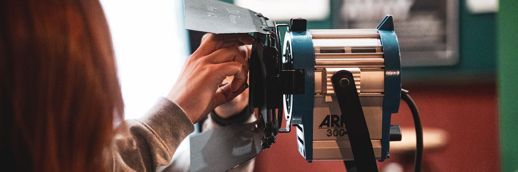 Closeup of a student adjusting film set lights