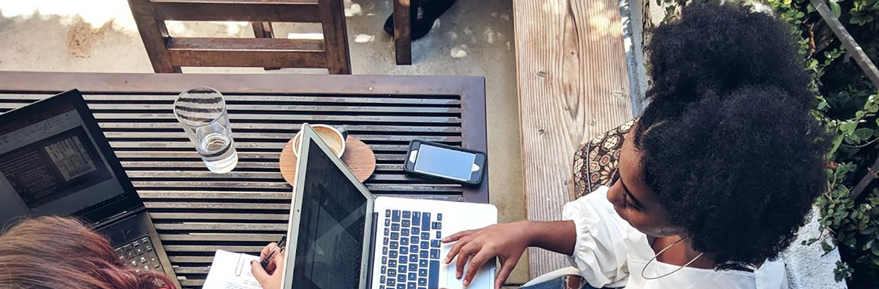 A student works on her computer outside the Indiana Memorial Union.